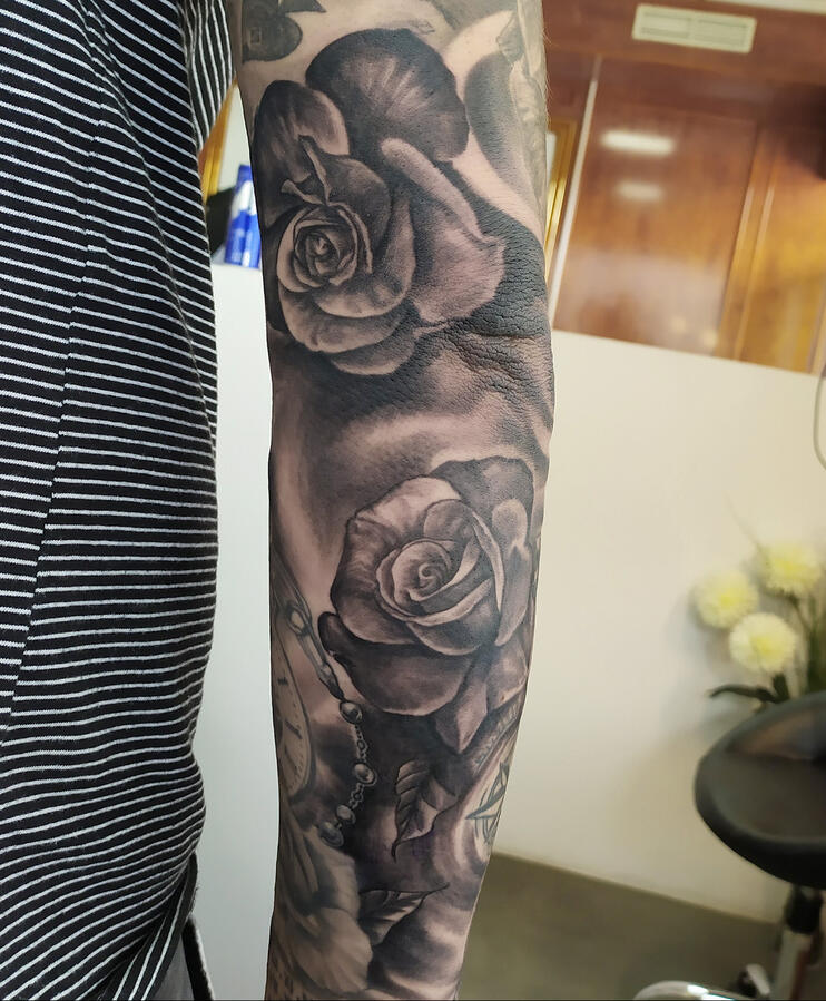 Realistic tattoo of roses. Gap filler over the elbow.